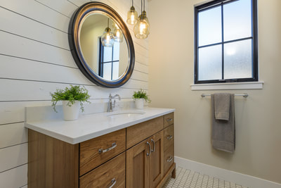 Interior guest bath with white shiplap wall treatment in Custom home in Bend, Oregon Northwest Crossing built by Structure Development NW an award winning homebuilder in Central Oregon. Farmhouse Style home with stunning interior design.