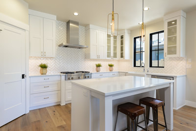 Interior Kitchen with all white cabinetry, countertops, and tile in Custom home in Bend, Oregon Northwest Crossing built by Structure Development NW an award winning homebuilder in Central Oregon. Farmhouse Style home with stunning interior design.